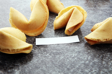 Fortune Cookies with blank paper on dark background
