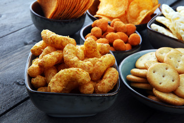 Salty snacks. Pretzels, chips, crackers in bowls