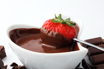 Fondue with Melting chocolate or melted chocolate and strawberry.