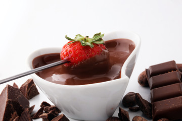 Fondue with Melting chocolate or melted chocolate and strawberry.