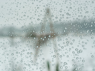 Frozen water drops on window at chilly winter time. Abstract textures on clean surface.