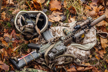 set of military equipment and rifle on the outdoor background