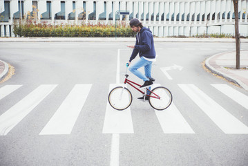 Male BMX rider on street with phone