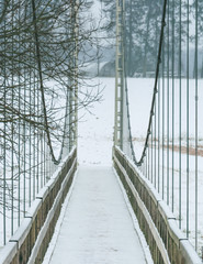 Fototapeta premium First snow in countryside. Fields covered in fog, icy roads and snow covered trees.