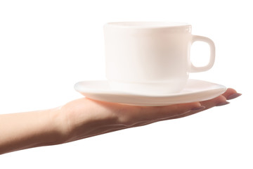 White cup and saucer in female hands isolated