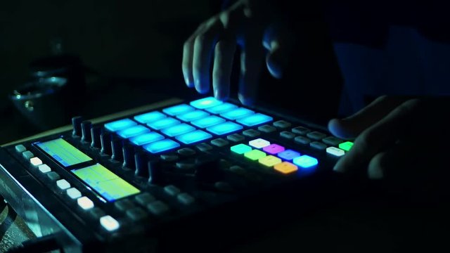 person dj plays live drums on the audio controller