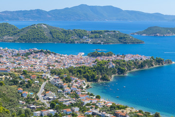 Amazing view of Skiathos town in Greece with traditional houses and Skopelos in background