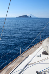 Deck of a sailing yacht and open sea with Liparian Islands (Stromboli), Italy