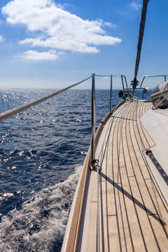 Railing of a wooden sailing yacht on open sea