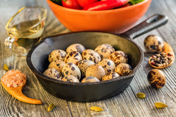 Quail eggs on old brown wooden surface