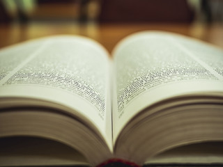 macro shot of the opened book on the table in the library