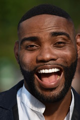 Unshaven Black Male And Laughter