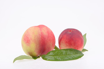 A few fresh peach on a white background