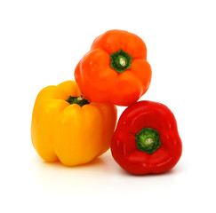 Fresh yellow, red and orangebell peppers isolated on white