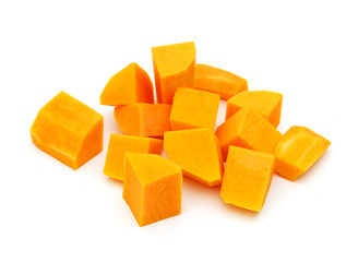 A group of cut and slice butternut squash chunks on a white background.