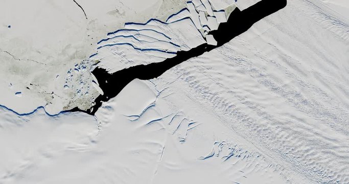 Very high-altitude overflight aerial of the breakup of Iceberg B-44 in Pine Island Bay, Antarctica  . Clip loops and is reversible. Elements of this image furnished by USGS/NASA Landsat