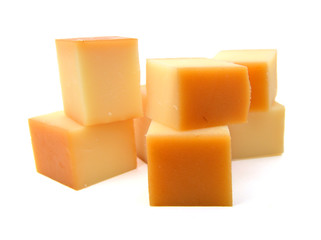 Cubes of cheddar cheese isolated on white