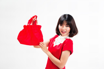 The lady in red dress put red bag up with smige and happy face,chinese new year concept