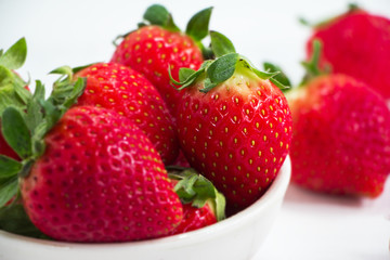 The red strawberry put on timber board,blurry light around.