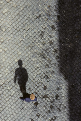 shadow of senior man on cobble stone