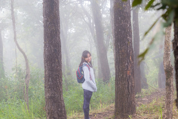 Asia teenager girl backpack behind go hiking or climbing in Nature Mountain.