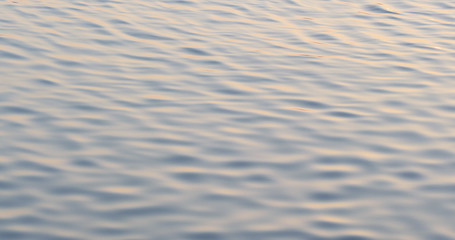 Water surface with a beautiful bokeh of sun glares