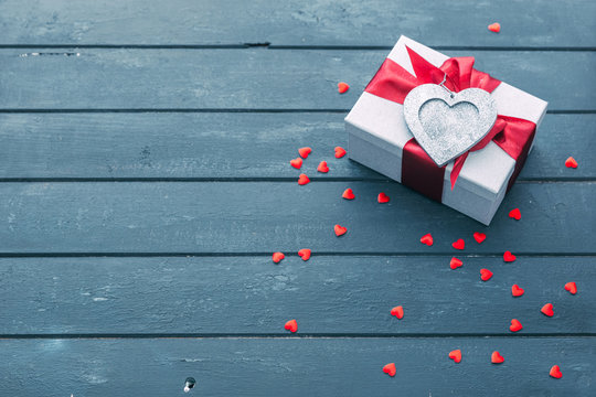 Valentines day background. gift box with bows and hearts on wooden background.