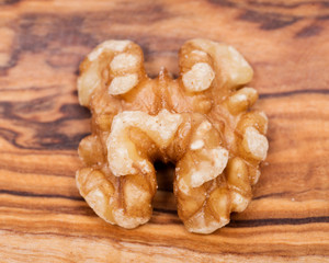 Raw premium walnut halves in wooden vintage bowl