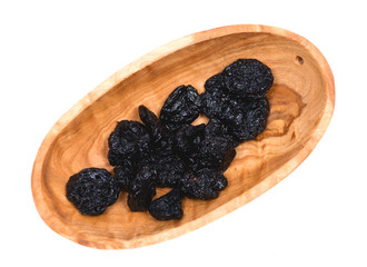 Organic unsweetened and unsulfured bing  dried cherries in wooden bowl isolated on white background
