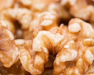 Raw premium walnut halves in wooden vintage bowl