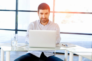 Handsome businessman working at computer