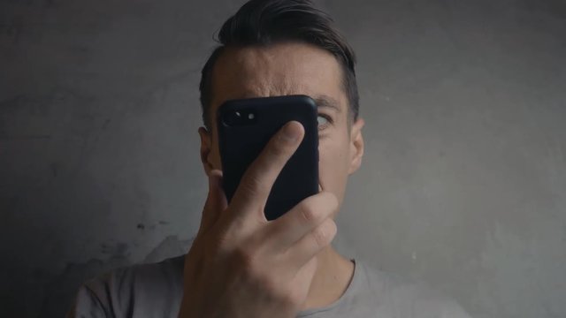 An angry man shouts to the phone