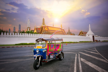 Naklejka premium Tuk-tuk for passenger cars To go sightseeing around the Grand Palace in Bangkok Thailand, with sunset sky background