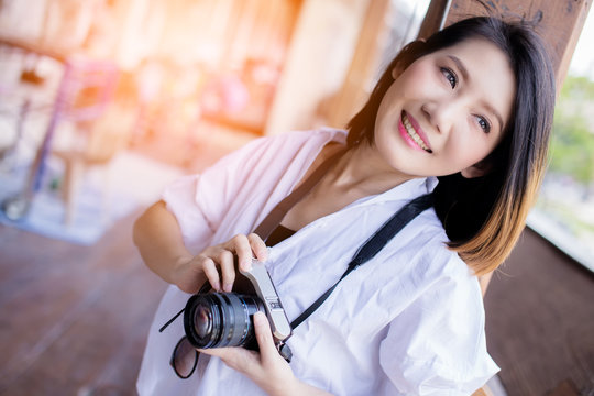 beautiful asian woman  casual costume with camera and travel stuff with background of old town city travel ideas concept