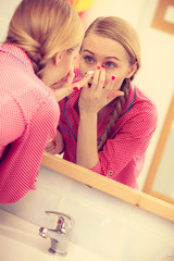 Woman applying moisturizing skin cream. Skincare.