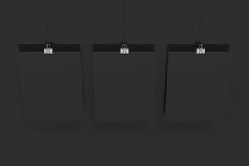 Three blank black posters with binder clip mockup on black background