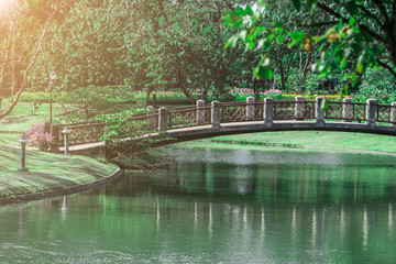 Fototapeta na wymiar Bridge and Pond in public park with Sun rise.