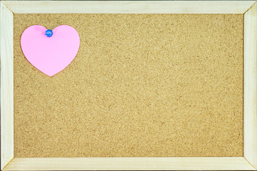 Pink Heart Paper with blue pin on cork board. Concept valentine'day