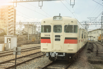 Naklejka na ściany i meble Railroad tracks in Japan with sunset. Transport by train