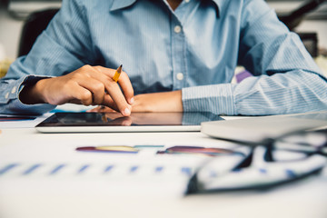 Businessmen working with laptop and smartphone in open space office. Meeting report in progress. sun glare effect