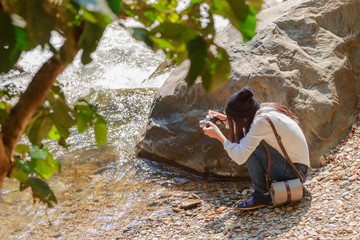 Woman hiking around mountains near the river at spring time.