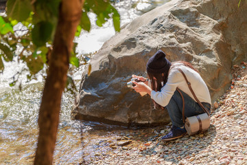 Woman hiking around mountains near the river at spring time.