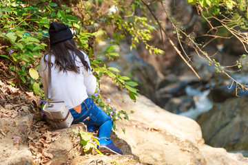 Woman hiking around mountains near the river at spring time.