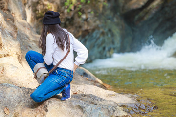 Woman hiking around mountains near the river at spring time.