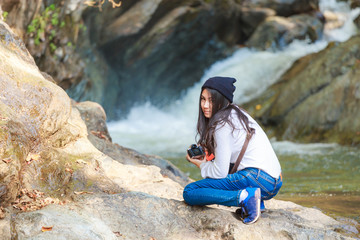 Woman hiking around mountains near the river at spring time.