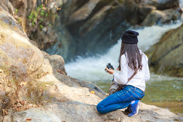 Woman hiking around mountains near the river at spring time.