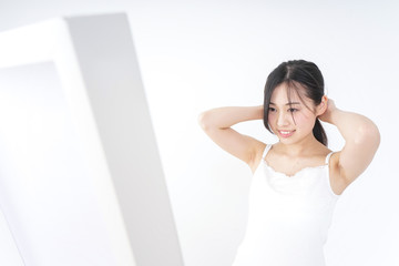 Young woman tying her hair