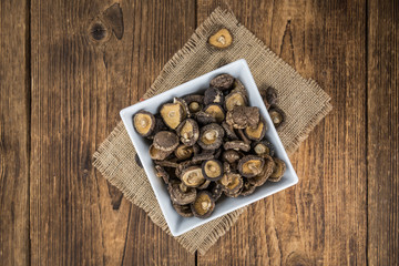 Wooden table with Dried Shiitake, selective focus