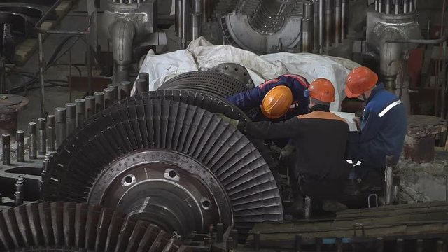 Engineer taking notes for maintenance steam turbine of thermal power plant