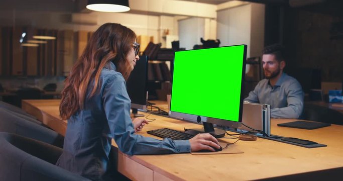 Man and woman colleagues professionals communicating while working together in modern office. Green screen chroma key. 4K UHD